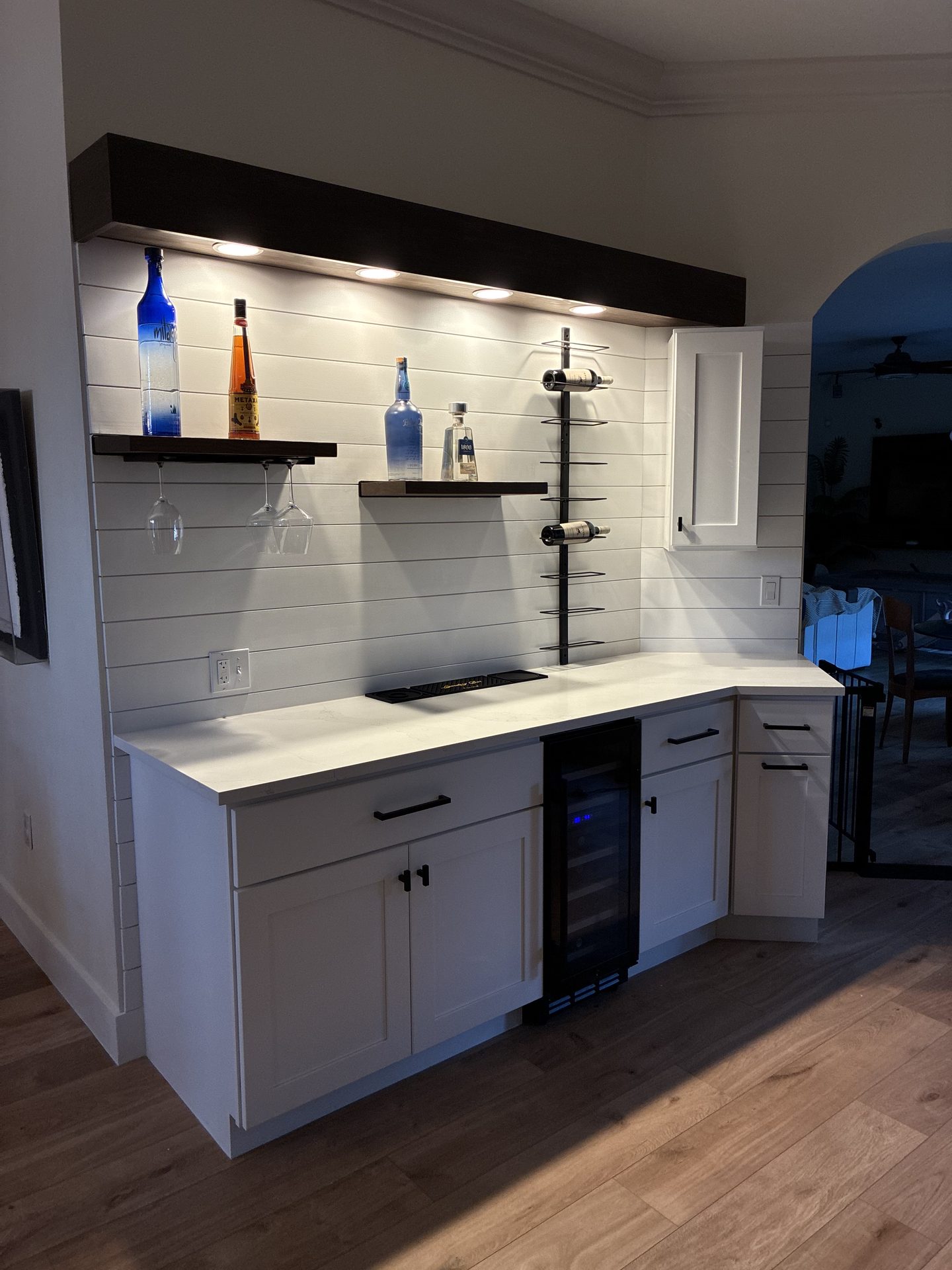 Custom bar build with shiplap backer, floating shelves, wine rack, and shaker cabinets by Aristotle Enterprises, Sarasota FL