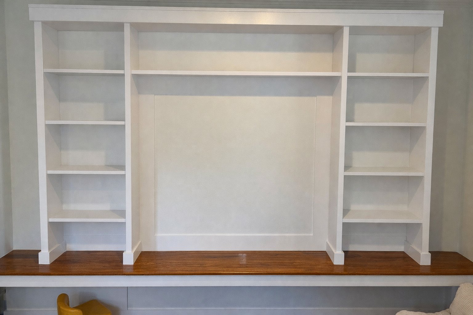 Custom built-in shelving unit with wood desktop
